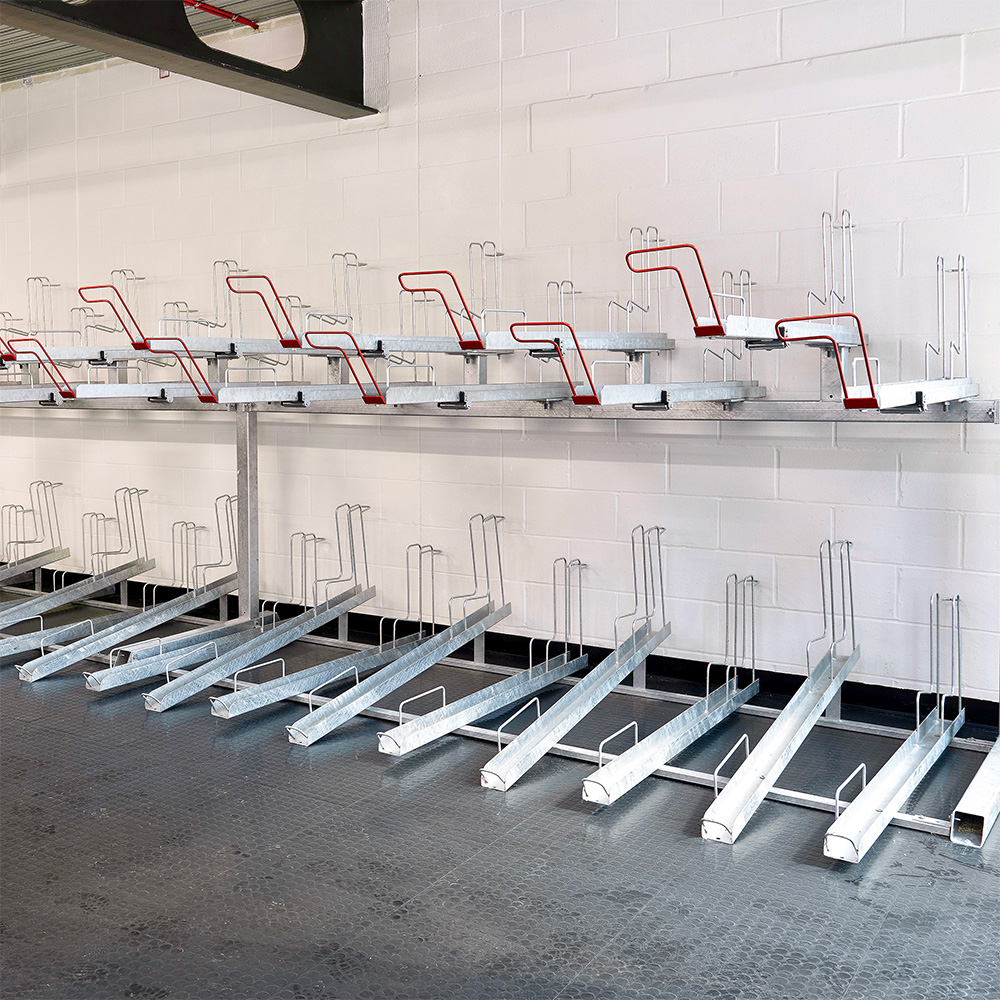 A row of Two Tier Cycle Racks inside of a commercial building