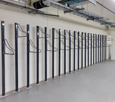 row of solo vertical bike racks stored in underground cycle storage