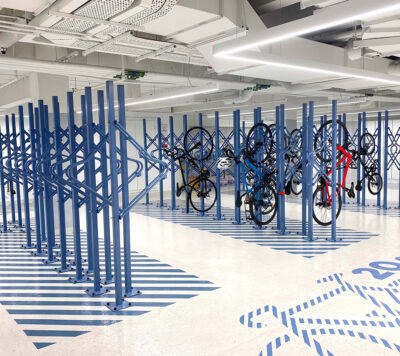 Premium Solo Vertical Bike Rack powder-coated in RAL blue installed in underground storage facility