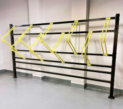 Premium Free Standing Vertical Bike Rack with yellow powdercoating installed in underground cycle storage facility